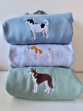 Load image into Gallery viewer, Three sweatshirts with custom full colour embroidered dogs on them, displayed in a stacked arrangement. Top tri coloured jack russell on a blue sweatshirt, middle a white and tan jack russell on a grey sweatshirt and bottom a tri colour brown collie on a dusty green sweatshirt.
